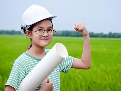 Elementary - Goals - Asian schoolgirl engineer with safety helmet and plans