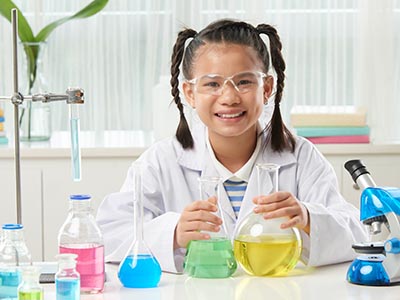 Elementary - Subjects - Asian schoolgirl in science lab